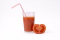 Sliced tomato and glass of tomato juice with straw