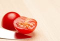 Sliced tomato with serated knife Royalty Free Stock Photo
