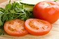 Sliced tomatoes, cucumber, parsley on cutting board meal prep Royalty Free Stock Photo