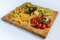 Assorted vegetables and fried potatoes on a cutting board Royalty Free Stock Photo