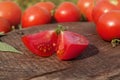 Sliced tomatoes on wooden table. Half  tomatoes on  wooden background Royalty Free Stock Photo