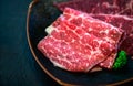 Sliced topside wagyu beef for yakiniku on plate on black background, Premium Japanese meat