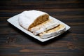 Sliced Traditional Christmas stollen cake with marzipan and dried fruit on wooden background Royalty Free Stock Photo