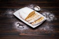 Sliced Traditional Christmas stollen cake with marzipan and dried fruit on wooden background Royalty Free Stock Photo