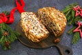 Sliced traditional Scottish Christmas Dundee fruit cake with dried fruit mix, garnished with peeled almonds on a wooden board