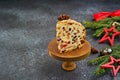 Sliced traditional Scottish Christmas Dundee fruit cake with dried fruit mix, garnished with peeled almonds on a wooden board