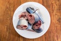 Sliced uncooked Pacific mackerel on dish on a rustic table