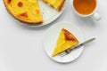 Sliced upside down pineapple cake with cup of tea on white table. Summer tropical dessert. Top view. Copy space Royalty Free Stock Photo