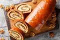 Sliced walnut roll made from yeast dough close-up on a wooden board. Horizontal top view Royalty Free Stock Photo