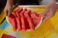 Sliced water melon served desert. Close up of cut watermelon holding by chef cook hands. Healthy food dessert at picnic party Royalty Free Stock Photo