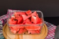 Sliced watermelon in glass container with black seeds on black background Royalty Free Stock Photo