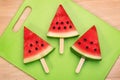 Sliced watermelon on green plastic wood cutting board