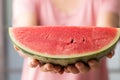 Sliced watermelon holding by womand hand