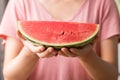 Sliced watermelon holding by womand hand