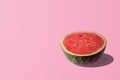 Sliced watermelon on pastel pink background. Minimal fruit concep