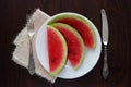 Sliced watermelon on white plate with knife and fork Royalty Free Stock Photo