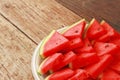 sliced watermelon on white plate and wooden background Royalty Free Stock Photo