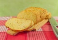 Sliced wheat bread on cutting Board closeup. Knife, red napkin