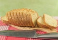 Sliced wheat bread on cutting Board closeup. Knife, red napkin