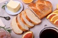 Sliced wheat bread surrounded by butter and orange