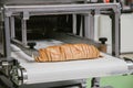 Sliced white bread in cutting machine, baking equipment selective focus