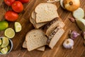 Sliced white bread with wheat flour on a wooden table. Chamado PÃÂ£o de forma