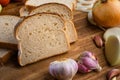 Sliced white bread with wheat flour on a wooden table. Chamado PÃÂ£o de forma