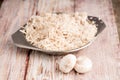 Sliced white champignon mushrooms on a wooden table Royalty Free Stock Photo