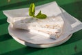 Sliced white nougat with almonds on wooden table Royalty Free Stock Photo