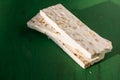Sliced white nougat with almonds on wooden table Royalty Free Stock Photo