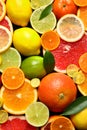 Sliced and whole citrus fruits with leaves as background Royalty Free Stock Photo