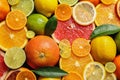 Sliced and whole citrus fruits with leaves as background Royalty Free Stock Photo