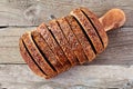 Sliced whole grain bread with flax, above view on wood