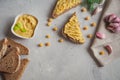 Sliced whole wheat bread with hummus, chickpea and garlic on the grey concrete backdrop. Royalty Free Stock Photo