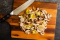 Sliced Wild Mushrooms with a Chef\'s Knife on a Wooden Cutting Board Royalty Free Stock Photo