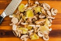 Sliced Wild Mushrooms with a Chef\'s Knife on a Wooden Cutting Board Royalty Free Stock Photo