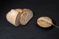 Sliced yeast grain bread with oats on dark concrete background Royalty Free Stock Photo