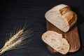 Sliced yeast grain bread with oats on dark concrete background Royalty Free Stock Photo