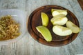 Sliced yellow apple on a cutting board and grated apple on a light wooden table Royalty Free Stock Photo