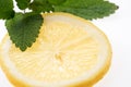 Sliced yellow lemon with leaves of fresh lemon balm Melissa officinalis Royalty Free Stock Photo