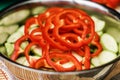 Sliced Zucchini And Red Bell Pepper In Stainless Steel Bowls.