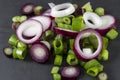 Slices of allum purple and green salad spring onions, scallions, macro.