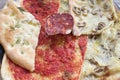 Slices of assorted pizza and salami Royalty Free Stock Photo