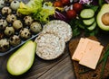 Slices of avocado on a wooden background, gluten-free bread, salad, green onions. Quail eggs. Healthy food. Vegetables