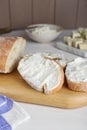 Slices of baguette with tofu cream cheese on white wooden table Royalty Free Stock Photo