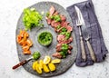 Slices of beef steak with chimmichuri sauce on gray stone plate Royalty Free Stock Photo