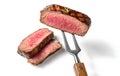 Slices of beef steak on a fork isolated on clean and white background Royalty Free Stock Photo