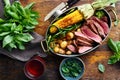 Slices beef steak in frying pan with vegetables and red wine Royalty Free Stock Photo