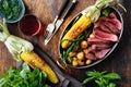 Slices beef steak in frying pan with vegetables and red wine Royalty Free Stock Photo