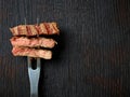Slices of beef steak on meat fork; from above Royalty Free Stock Photo